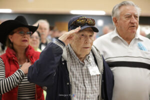 WWII Veteran Bill McIntyre salutes during Fort Worth Roll Call Lunch January 2022