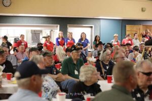 Roll Call Fort Worth Veterans and volunteers listen as Korean War Veteran Jim Sharp speaks May 2023