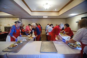 Roll Call Fort Worth Volunteers prepare meals for monthly luncheon March 2023